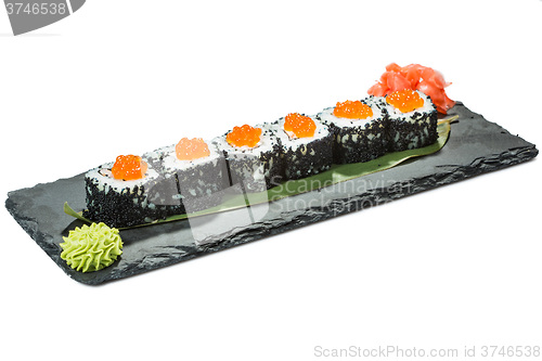 Image of set of sushi on black slate substrate, isolated white background