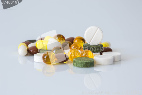 Image of Pile of various colorful pills isolated on white