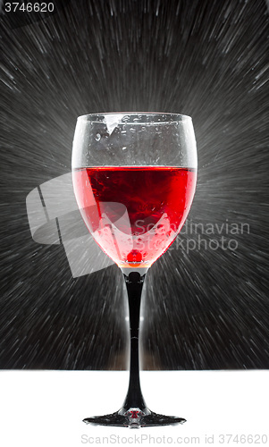 Image of glass with red wine. splashing water