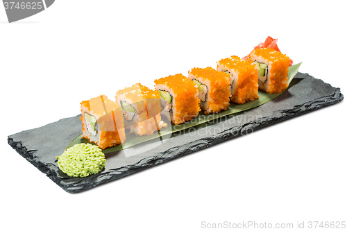 Image of set of sushi on black slate substrate, isolated white background