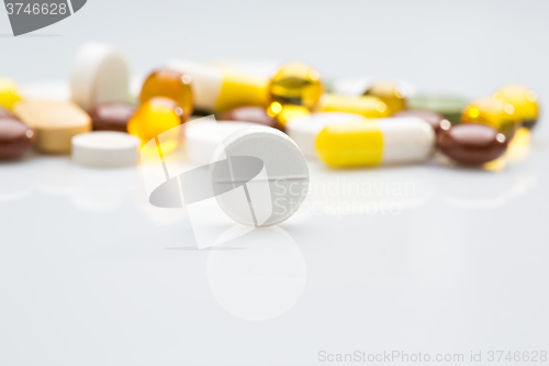 Image of Pile of various colorful pills isolated on white