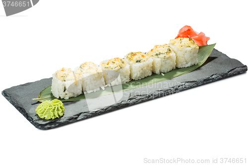 Image of set of sushi on black slate substrate, isolated white background