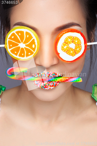 Image of Beautiful pin-up girl holding sweet lollipop
