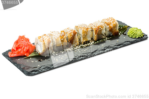 Image of set of sushi on black slate substrate, isolated white background