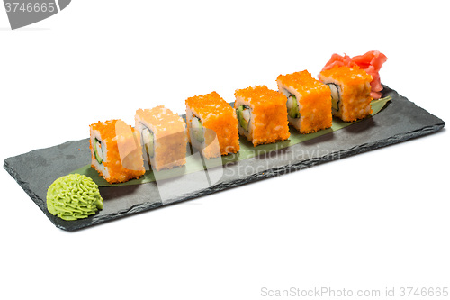 Image of set of sushi on black slate substrate, isolated white background