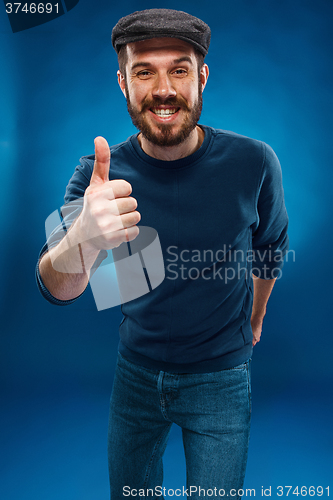 Image of The young man showing  the ok thumbs up hand sign