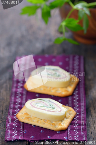 Image of Sliced cheese with ham and parsley