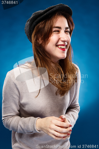 Image of The happy laughing girl on  blue background.