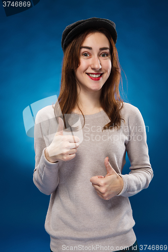 Image of The young girl showing  the ok thumbs up hand sign