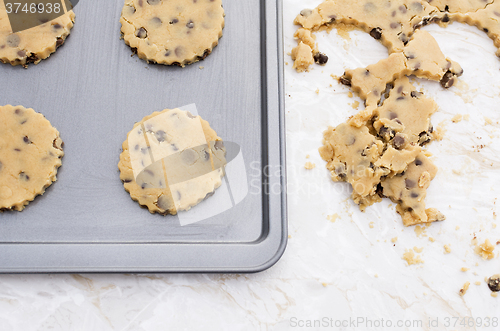 Image of Four chocolate chip cookies on a baking tray