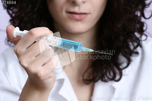 Image of Portrait of a young doctor with syringa.