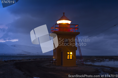 Image of Orange lighthouse at night, Iceland