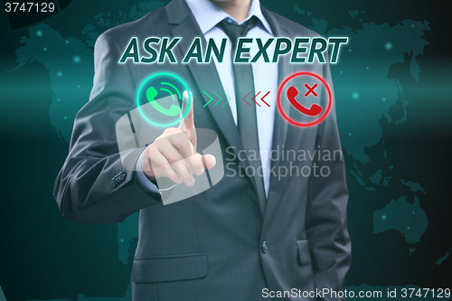 Image of Businessman pressing button on touch screen interface and select Ask an expert. Business concept. telephone call