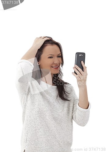 Image of Woman Using a Smartphone Like a Mirror
