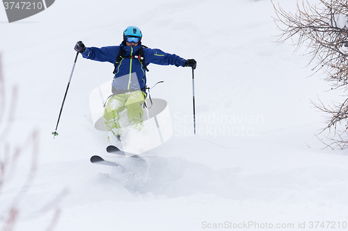 Image of freeride skier skiing in deep powder snow