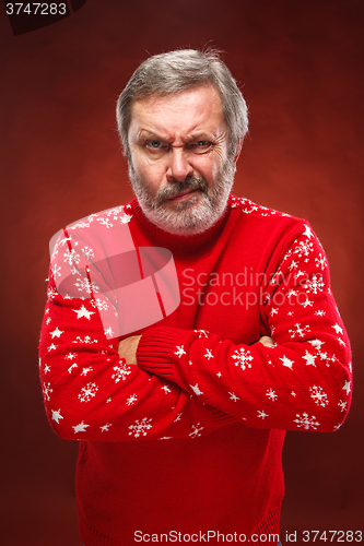 Image of The expressive portrait on red background of a pouter man 