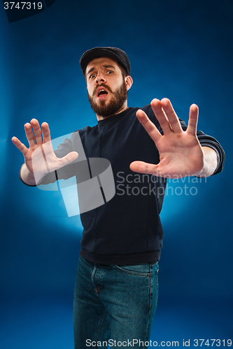 Image of Young handsome man scared, shocked facial expression