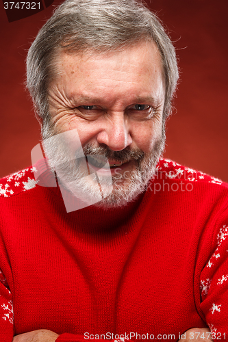 Image of The expressive portrait on red background of a pouter man 