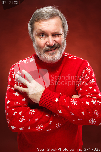 Image of The expressive portrait on red background of a pouter man 