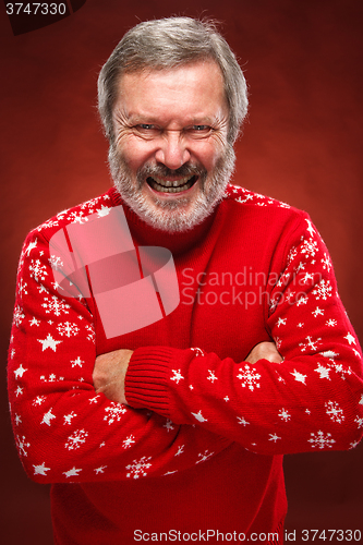 Image of The expressive portrait on red background of a pouter man 