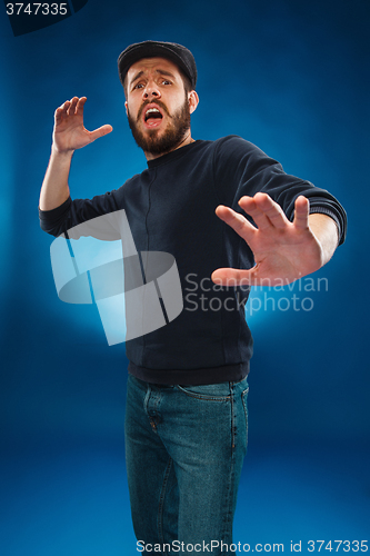 Image of Young handsome man scared, shocked facial expression