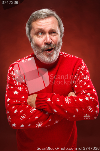 Image of The expressive portrait on red background of a pouter man 