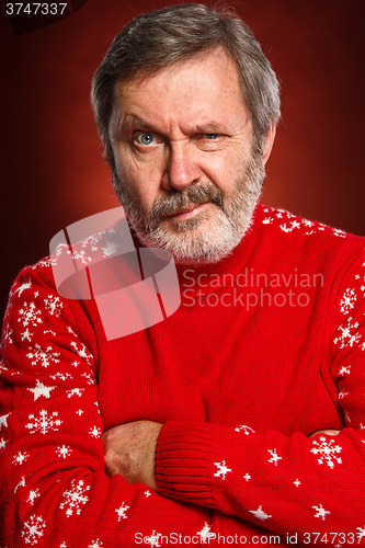 Image of The expressive portrait on red background of a pouter man 