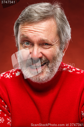 Image of The expressive portrait on red background of a pouter man 