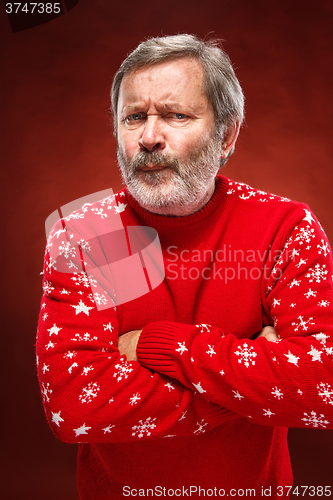 Image of The expressive portrait on red background of a pouter man 