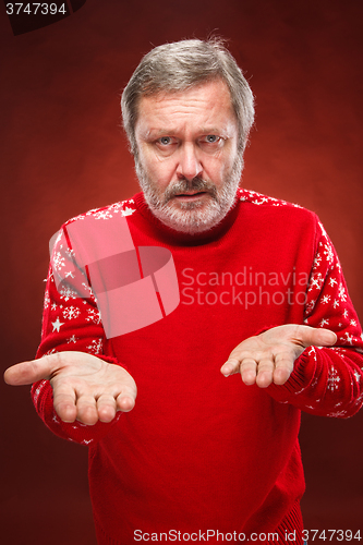 Image of The expressive portrait on red background of a pouter man 