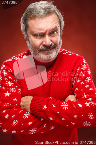 Image of The expressive portrait on red background of a pouter man 