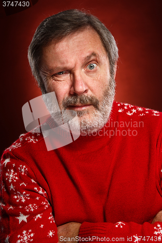 Image of The expressive portrait on red background of a pouter man 