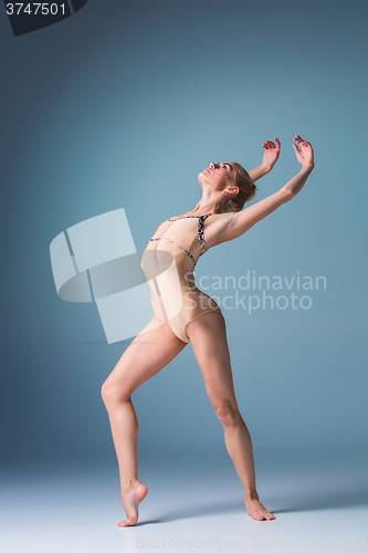 Image of Young beautiful modern style dancer posing on a studio background