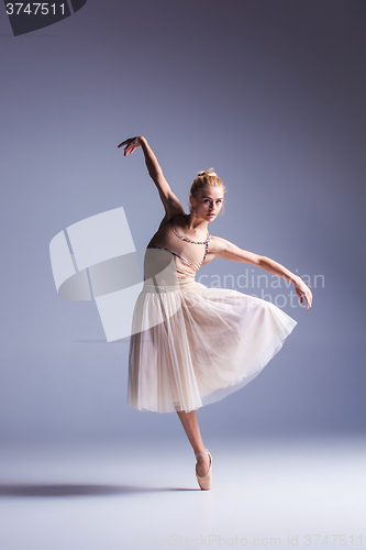 Image of Young beautiful modern style dancer posing on a studio background