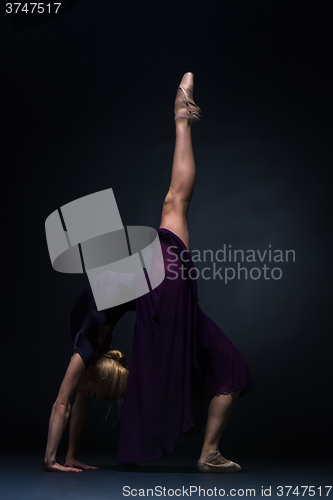 Image of Young beautiful modern style dancer posing on a studio background