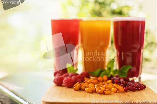 Image of fruit drink with cranberries raspberries and sea buckthorn