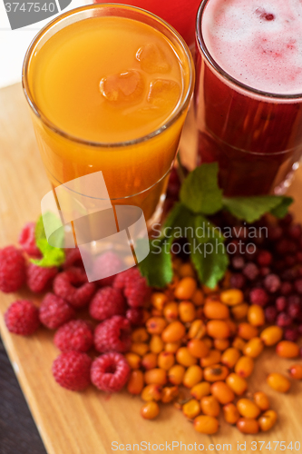 Image of fruit drink with cranberries raspberries and sea buckthorn