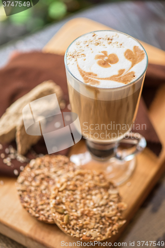 Image of coffee latte cup with cookies