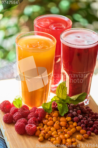 Image of fruit drink with cranberries raspberries and sea buckthorn