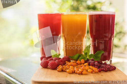 Image of fruit drink with cranberries raspberries and sea buckthorn