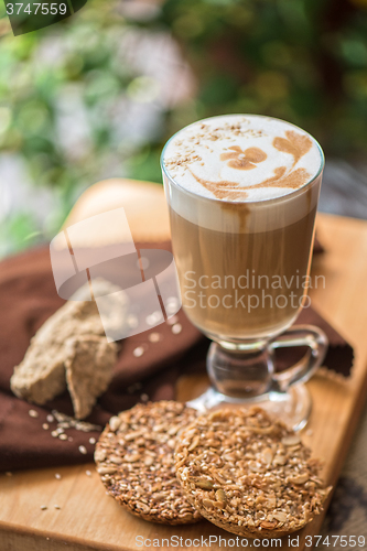 Image of coffee latte cup with cookies