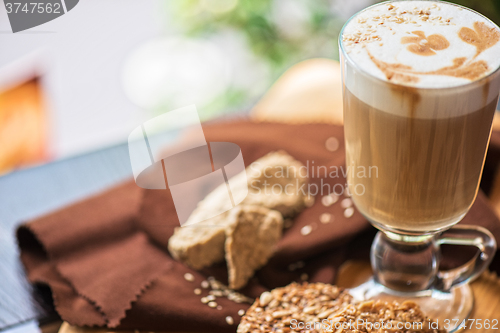 Image of coffee latte cup with cookies