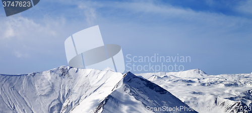 Image of Panoramic view on snowy mountains at sunny day