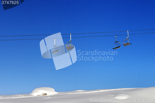 Image of Chair-lift and blue clear sky at sunny day