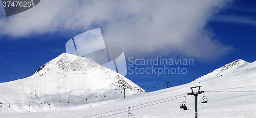 Image of Panoramic view on chair-lift and ski slope at sun day