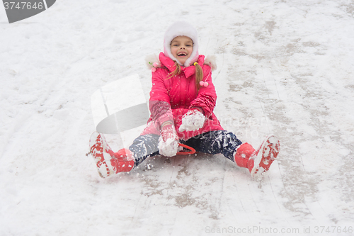 Image of Girl having fun rolling ice slides