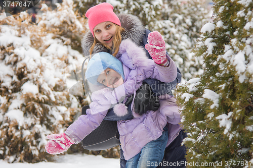 Image of Mom and daughter having fun five-year look out for trees