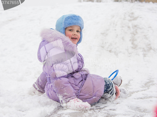 Image of  Girl with snow-covered rolling hills backwards