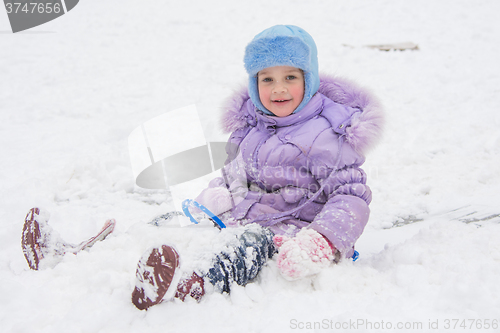 Image of Happy little girl slid down the icy hill