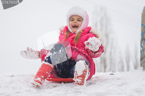 Image of Girl shouting and rejoicing rolling ice slides